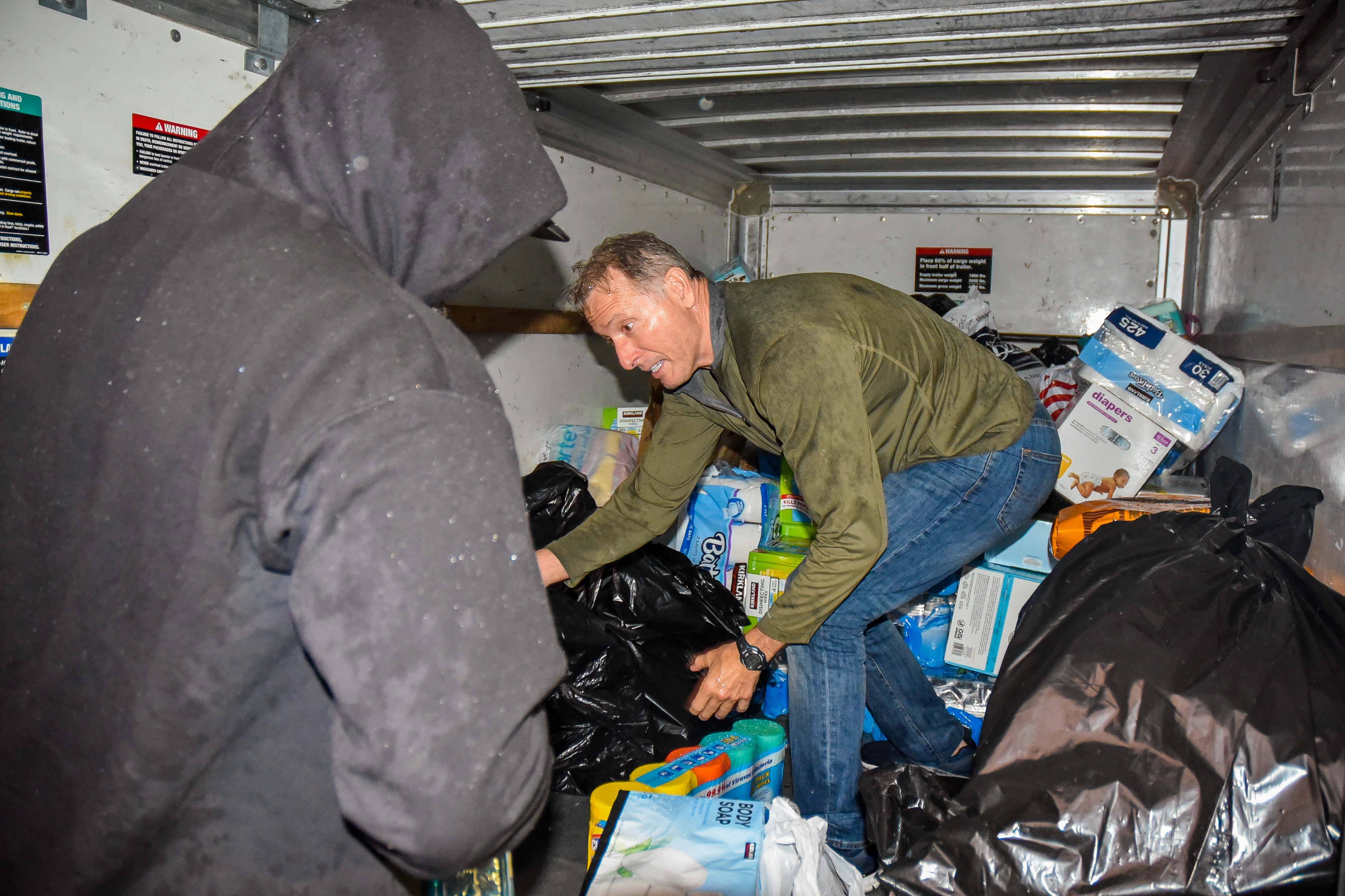 San Joaquin Delta College counselor Rocky LaJeunesse helps fill a trailer with donated items for fire victims.