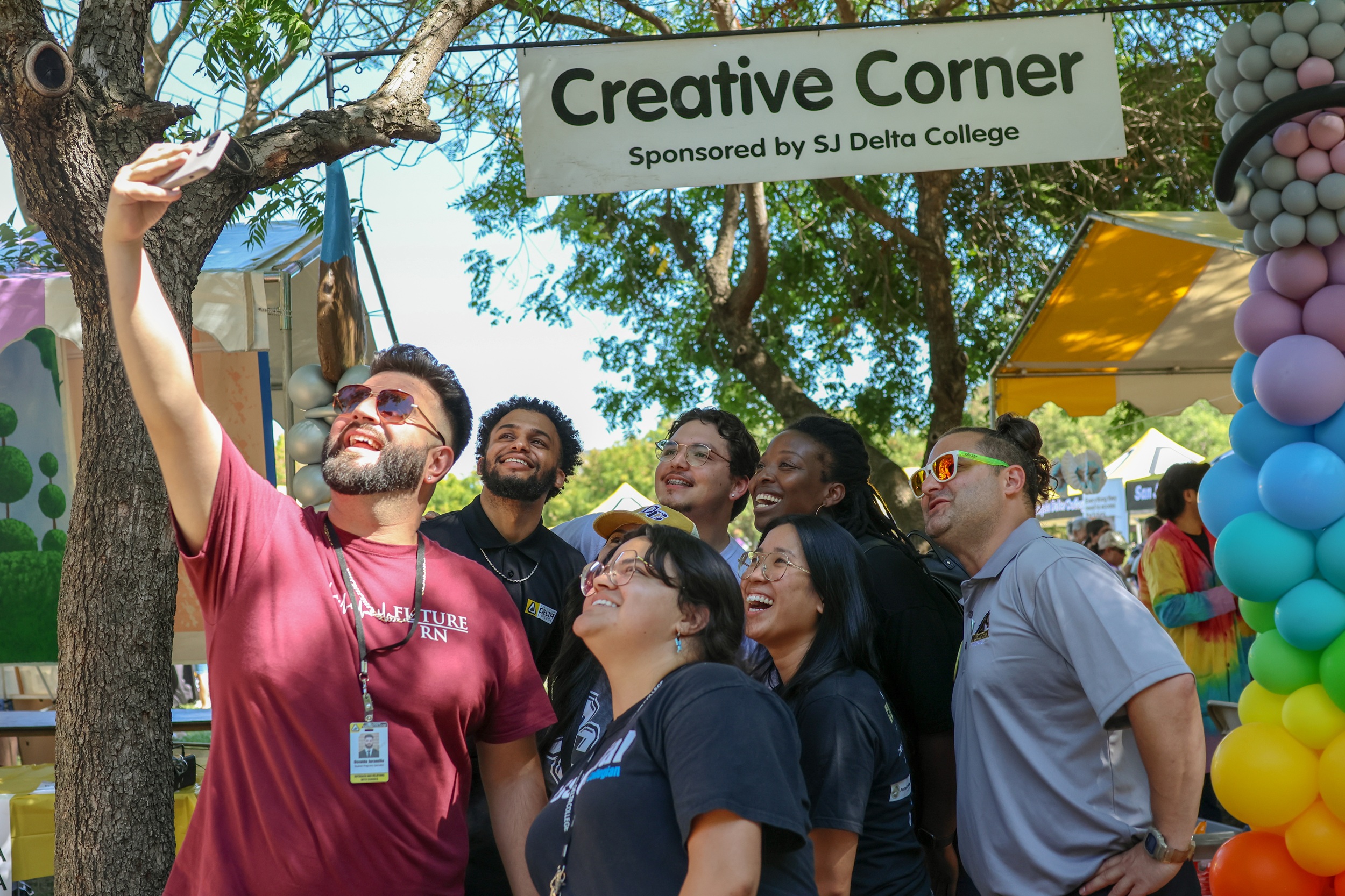 Outreach staff pose for photos at Family Day at the Park