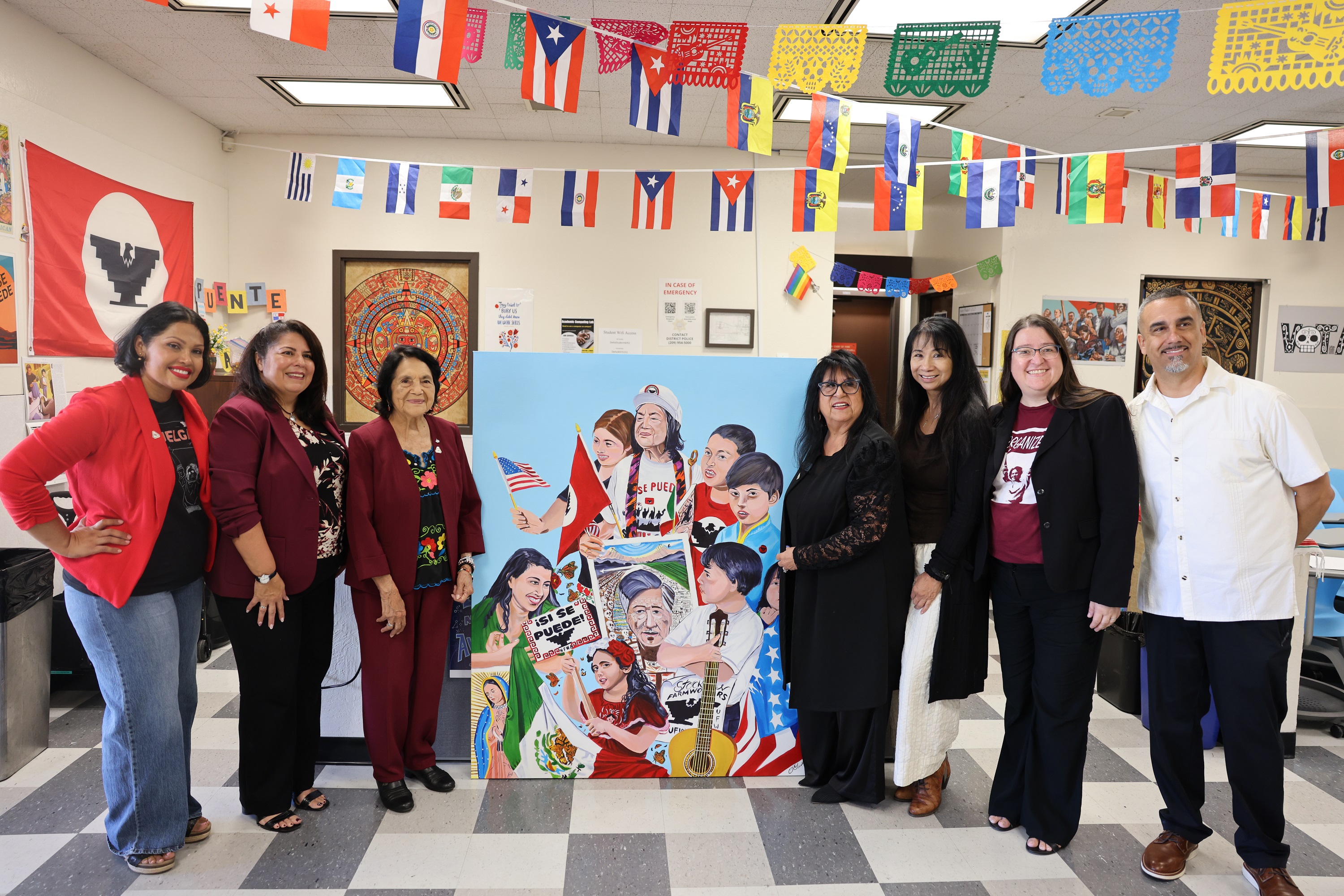 Photo of Dolores Huerta posing with Delta College faculty and leadership