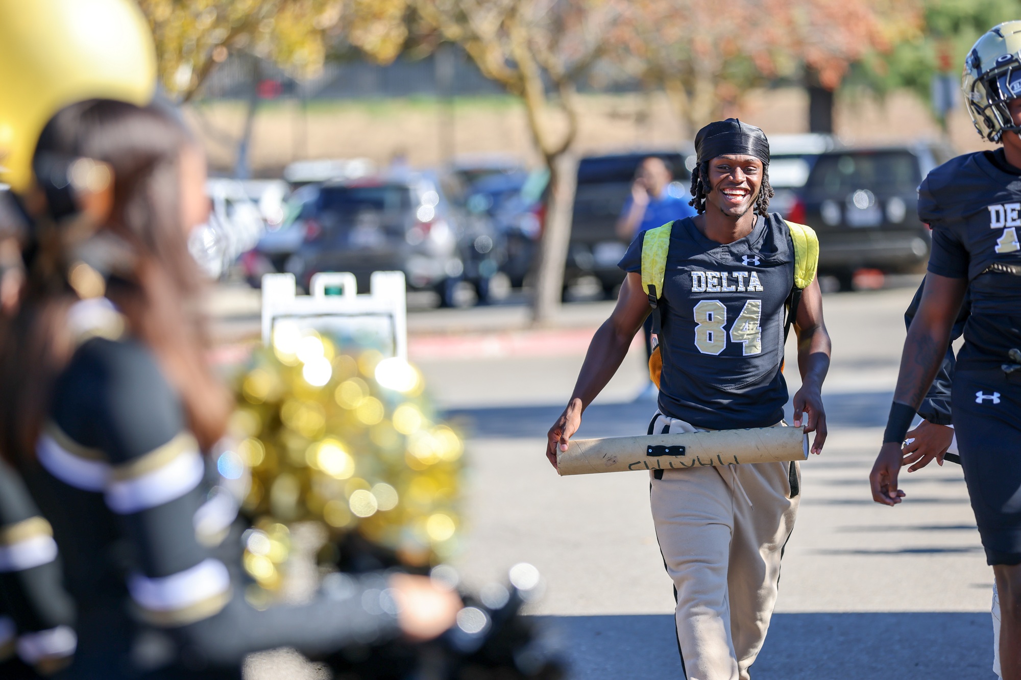 A Mustang football player smiles as he arrives at the new football field.