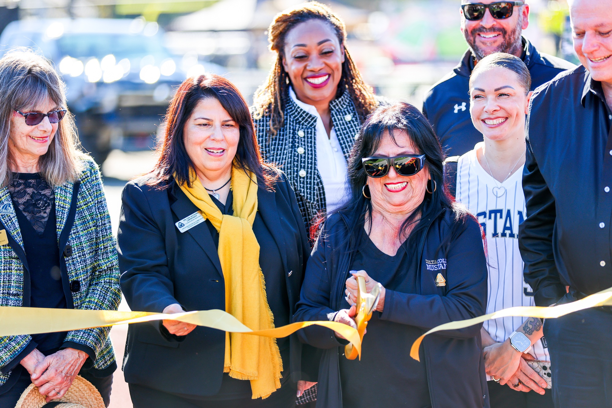 College leadership cutting the ribbon for the grand reopening of athletics facilities.