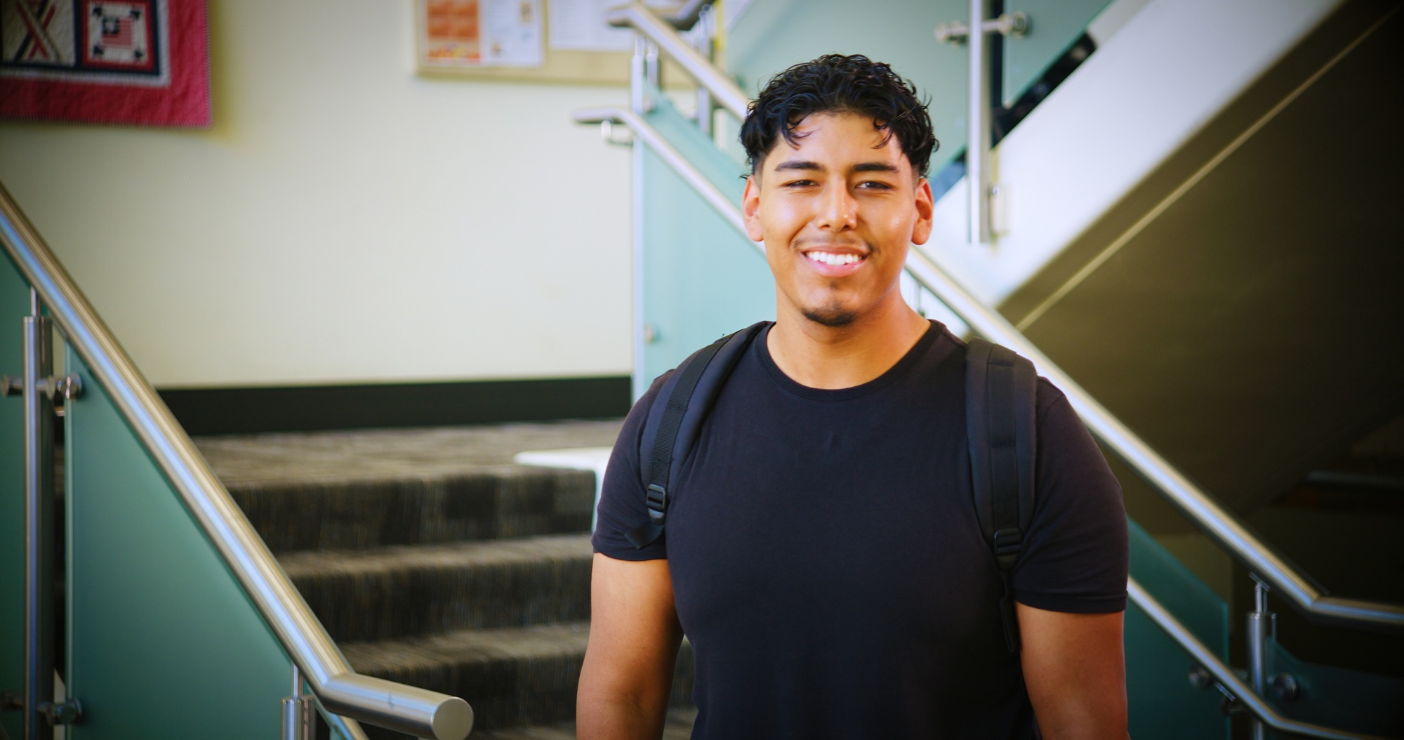 A student poses for the camera in the Delta College Library.