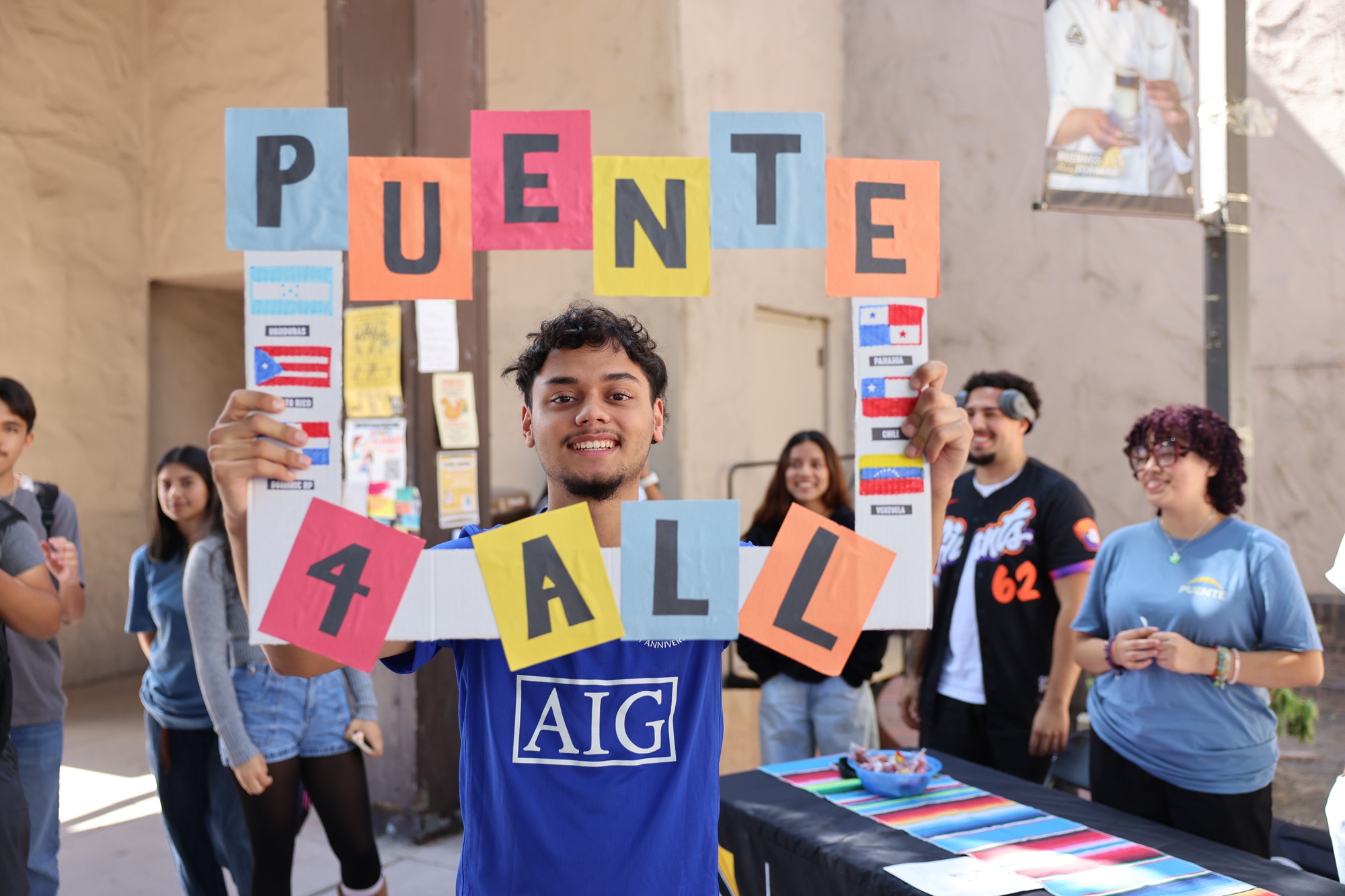 A Puente student holds a sign in the Delta College Quad