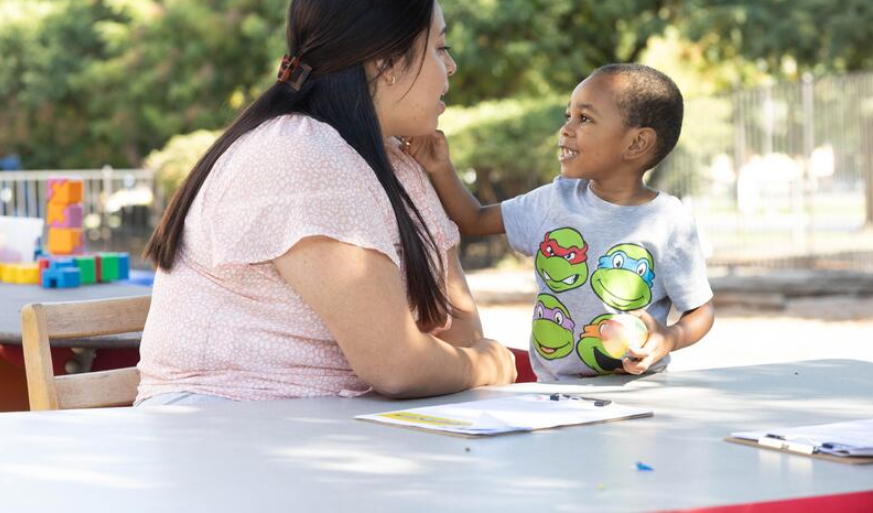 Photo of a student teaching a child at the Child Development Center