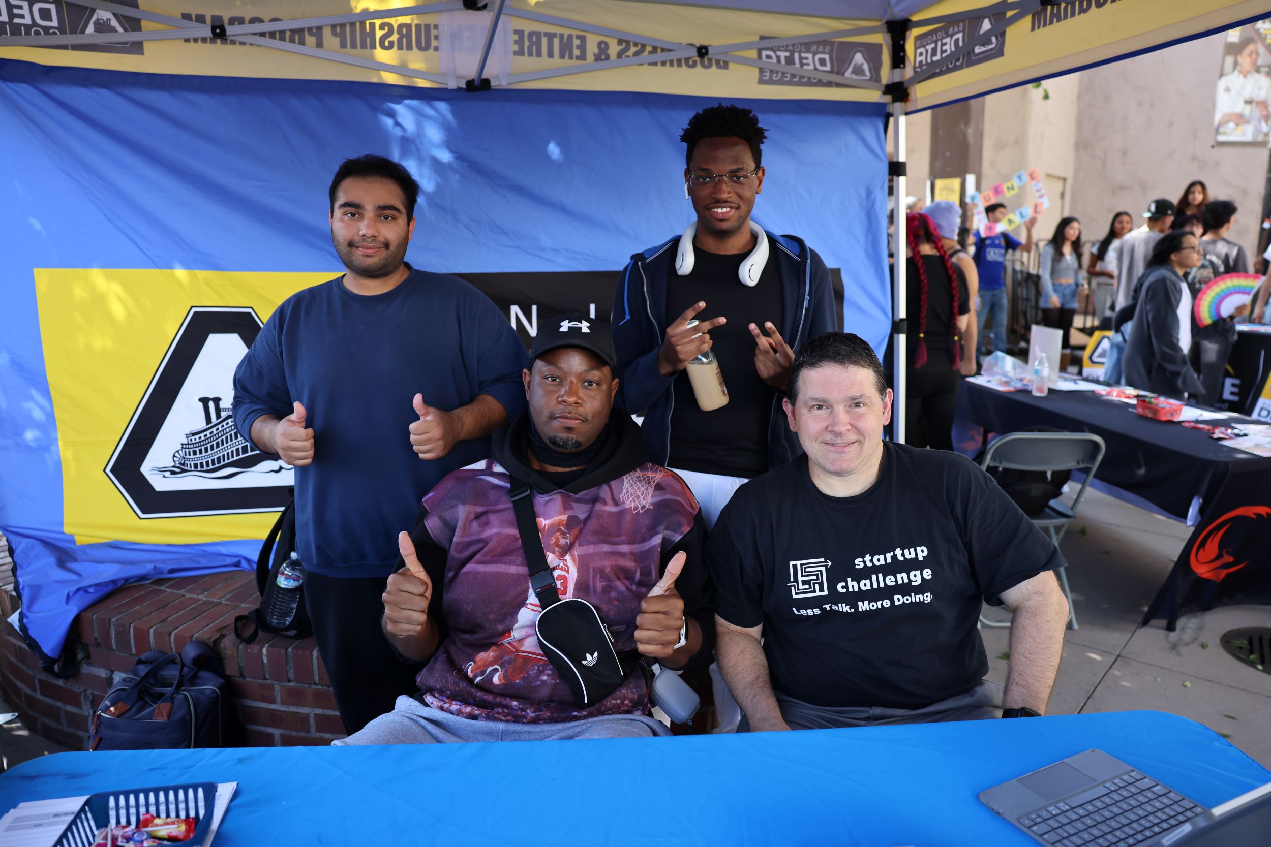 Students smiling while tabling at Club Rush event