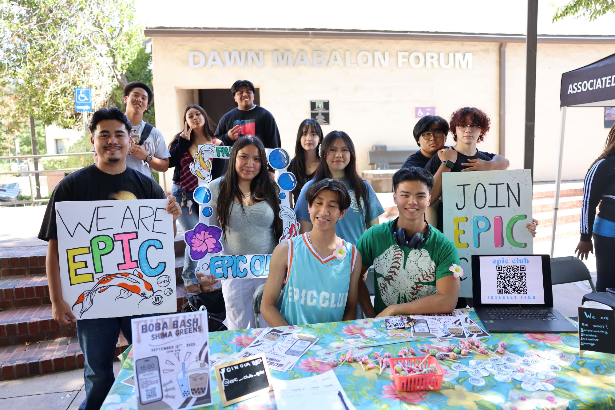 Students smiling while tabling at Club Rush event