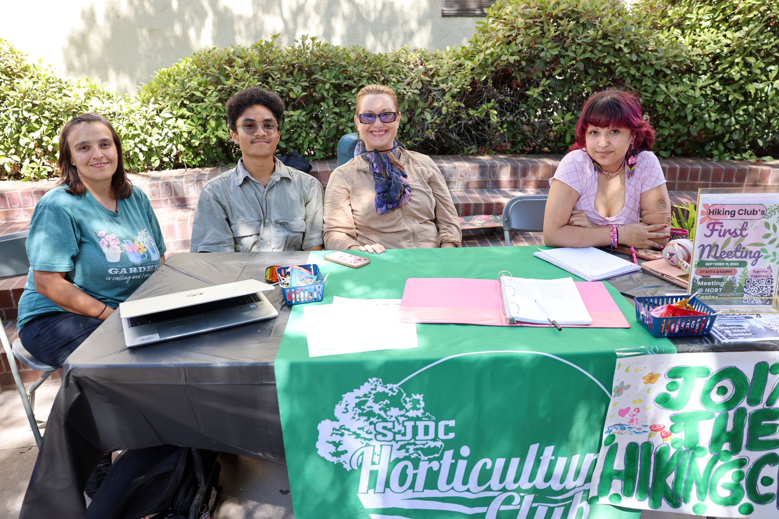 Students smiling while tabling at Club Rush event