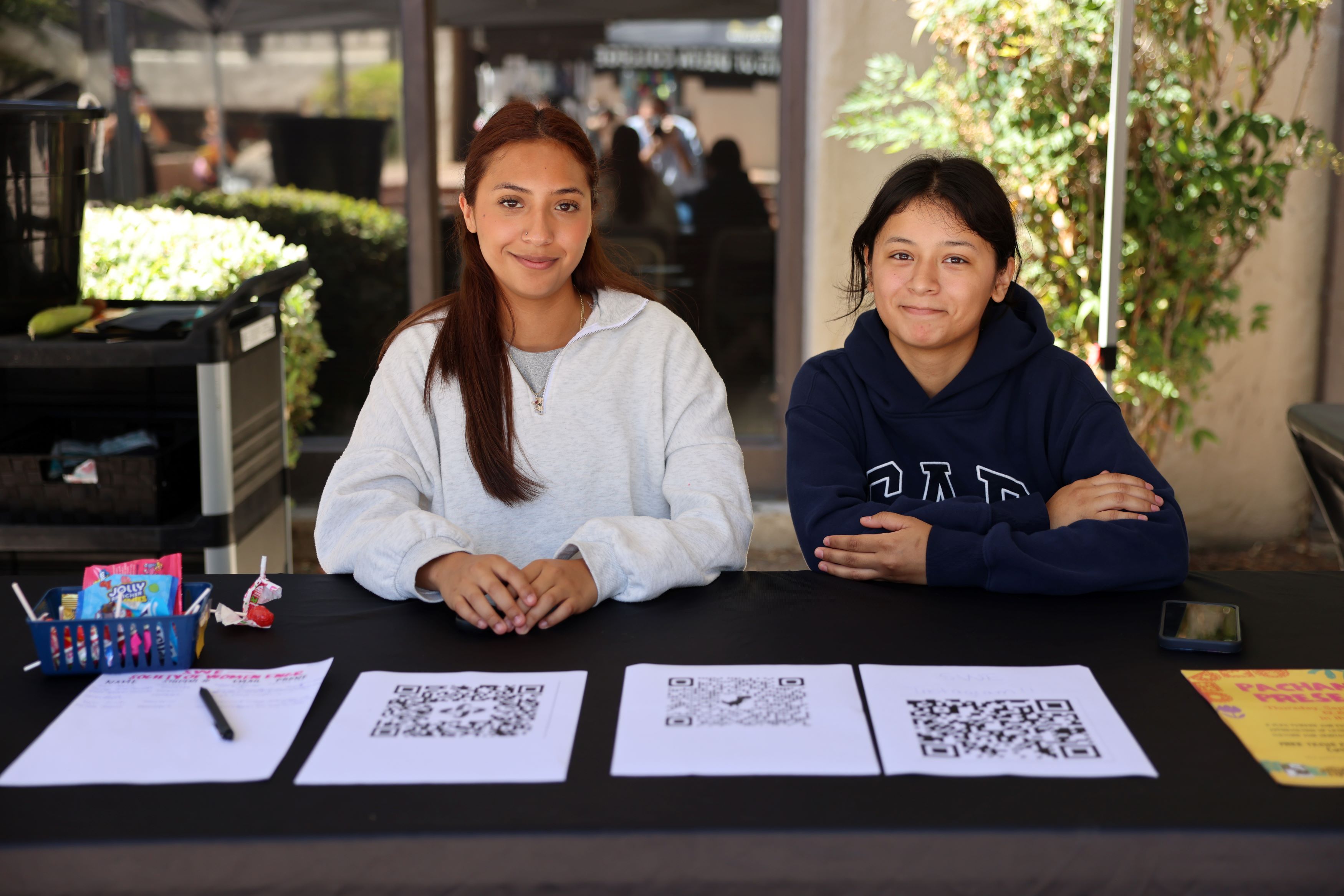 Two students sitting at their club's table during Club Rush