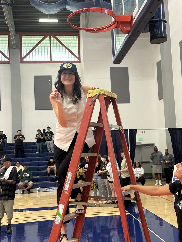 Coach Gina Johnson cutting down the nets