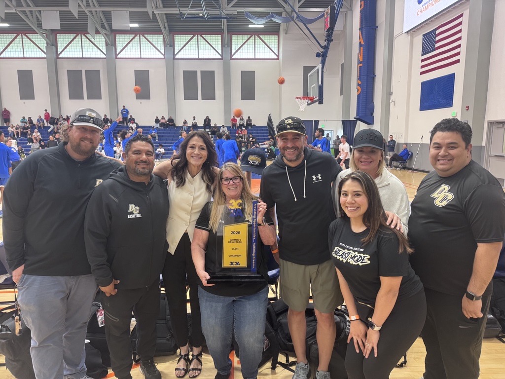 Staff celebrate the women's basketball championship
