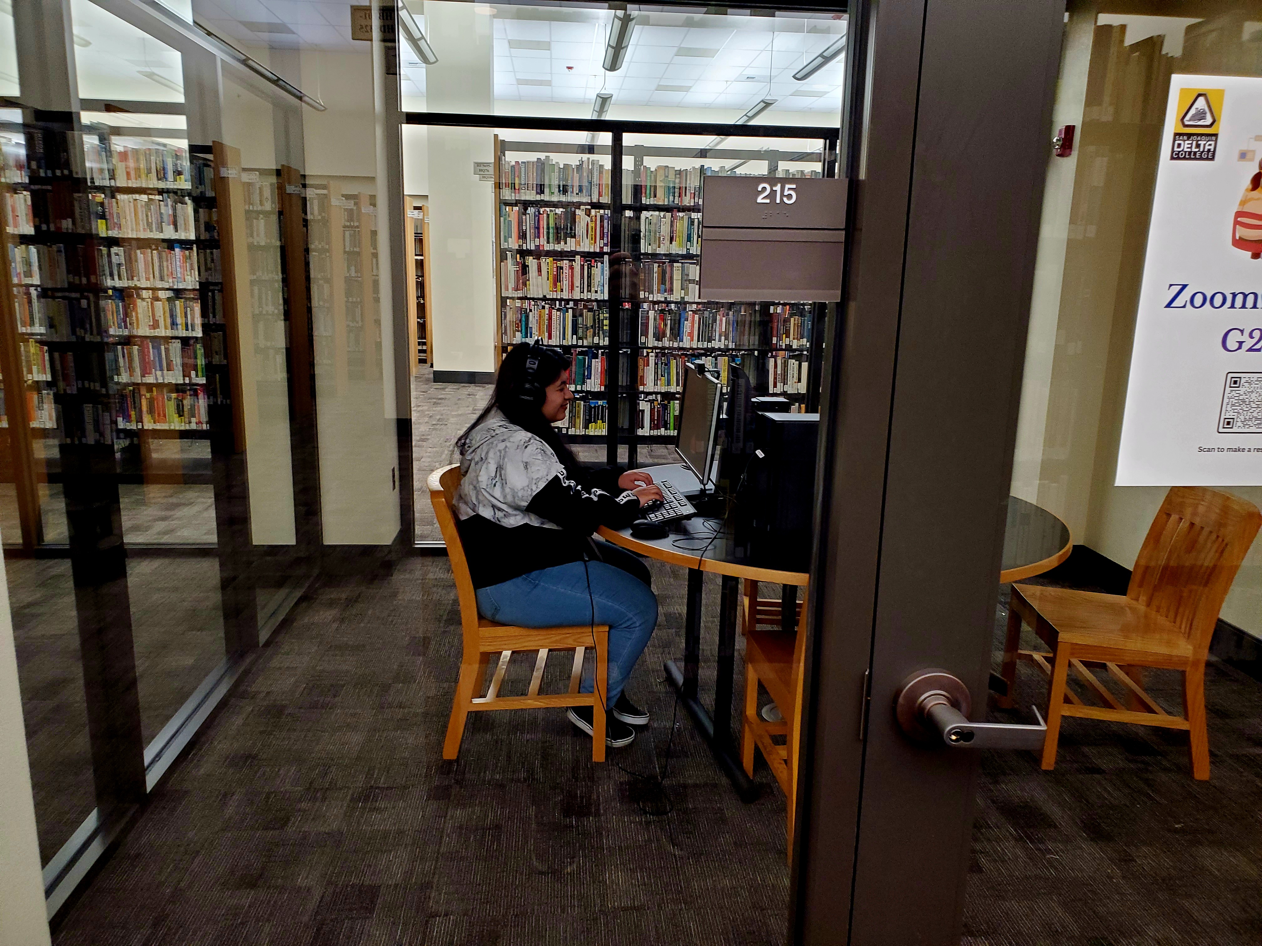 Photo of a student using a computer in the Zoom room