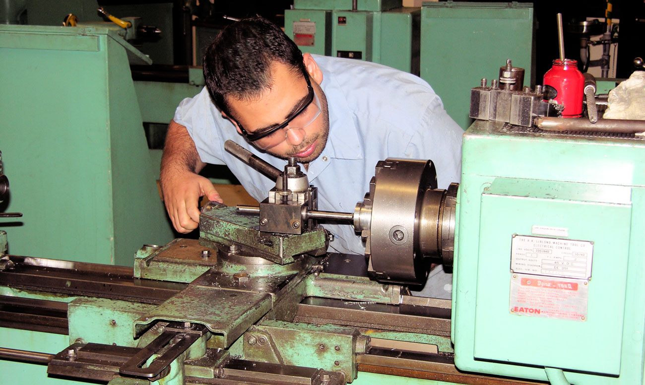 Machine shop students works on a project