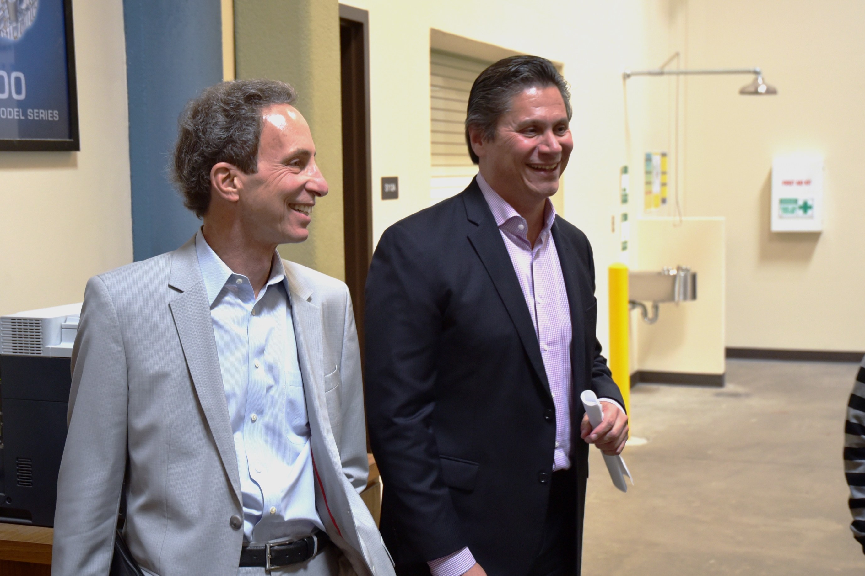 California Community Colleges Board of Regents President Tom Epstein, left, and Chancellor Eloy Oakley tour San Joaquin Delta College's Caterpillar heavy equipment facility.