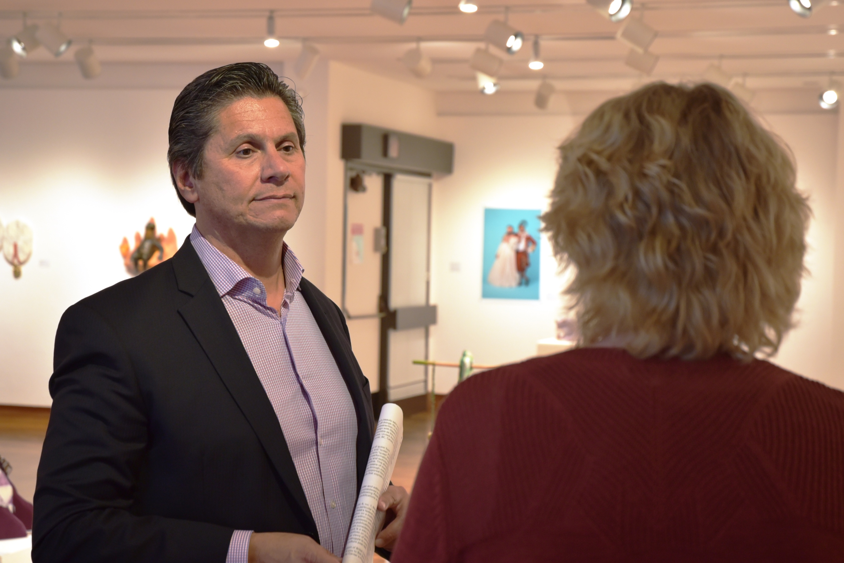 Chancellor Eloy Oakley listens to L.H. Horton Jr. Art Gallery Director Jan Marlese during his visit to San Joaquin Delta College.