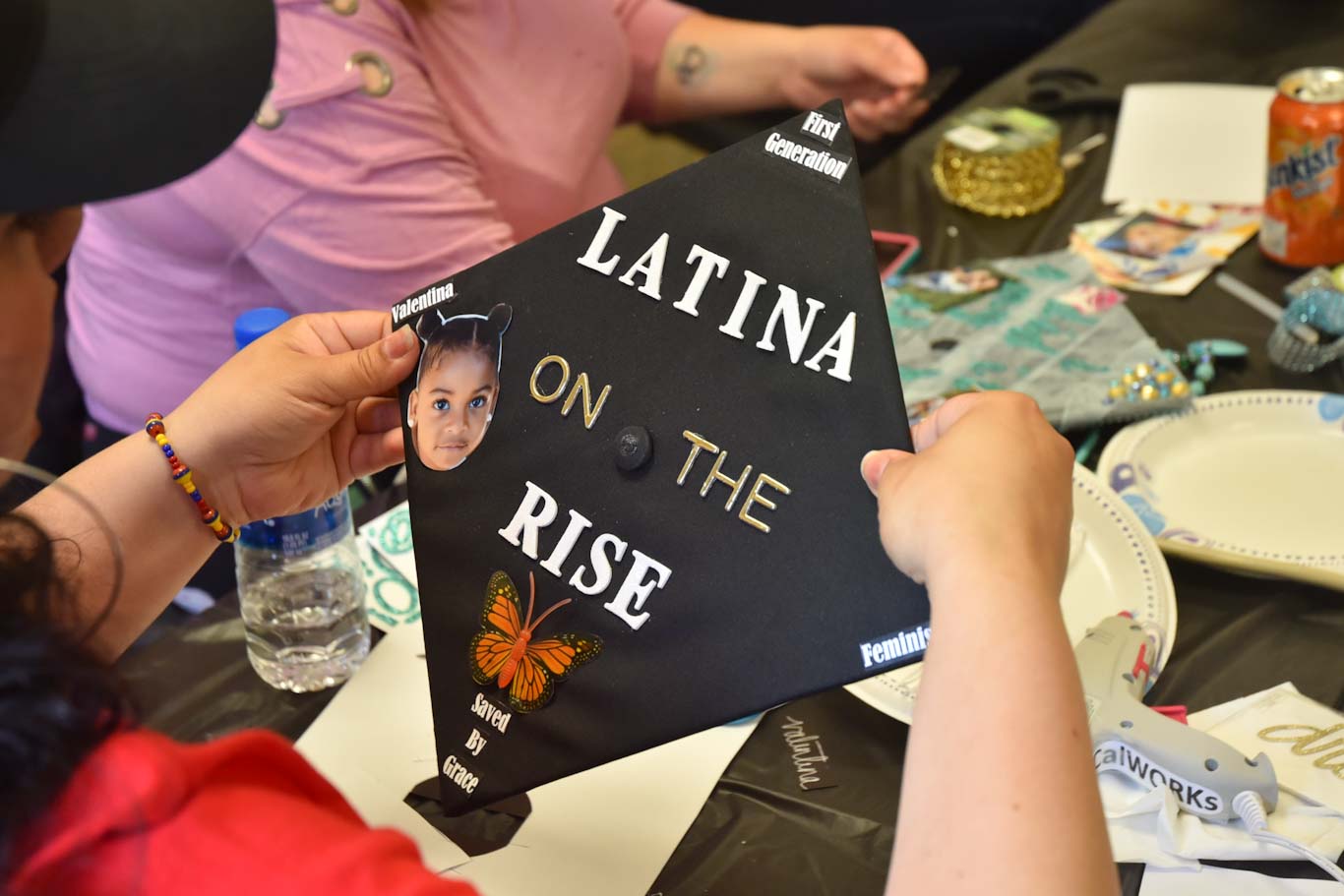 Vivian Medina's commencement cap includes a photo of her daughter Valentina and phrases that are important to her, like "first generation," "saved by grace" and "feminist." She is graduating from San Joaquin Delta College next week.