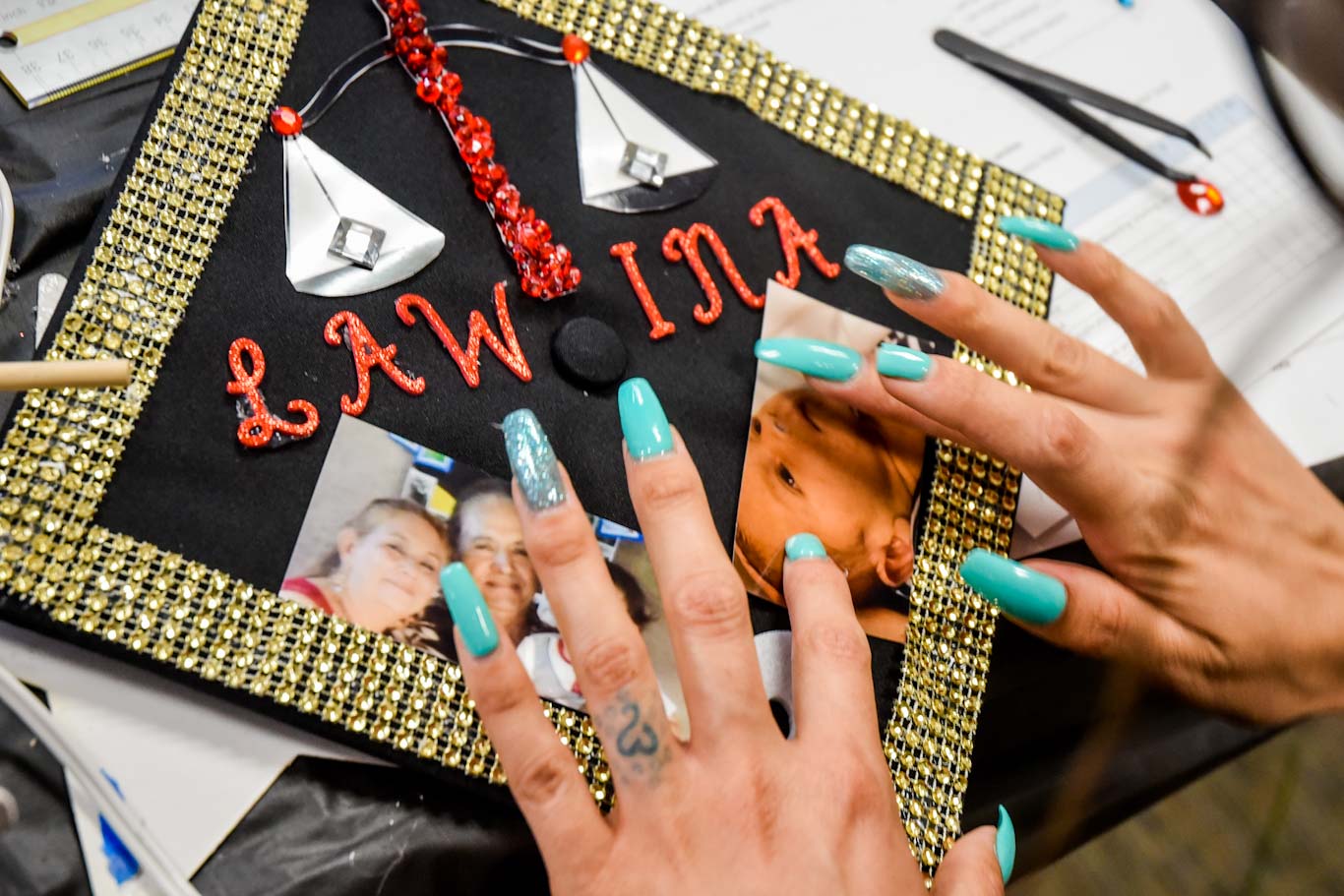 Graciela Villa's commencement cap includes a photo of her son, Adan, and of her parents. Graciela is the first member of her family to finish college.
