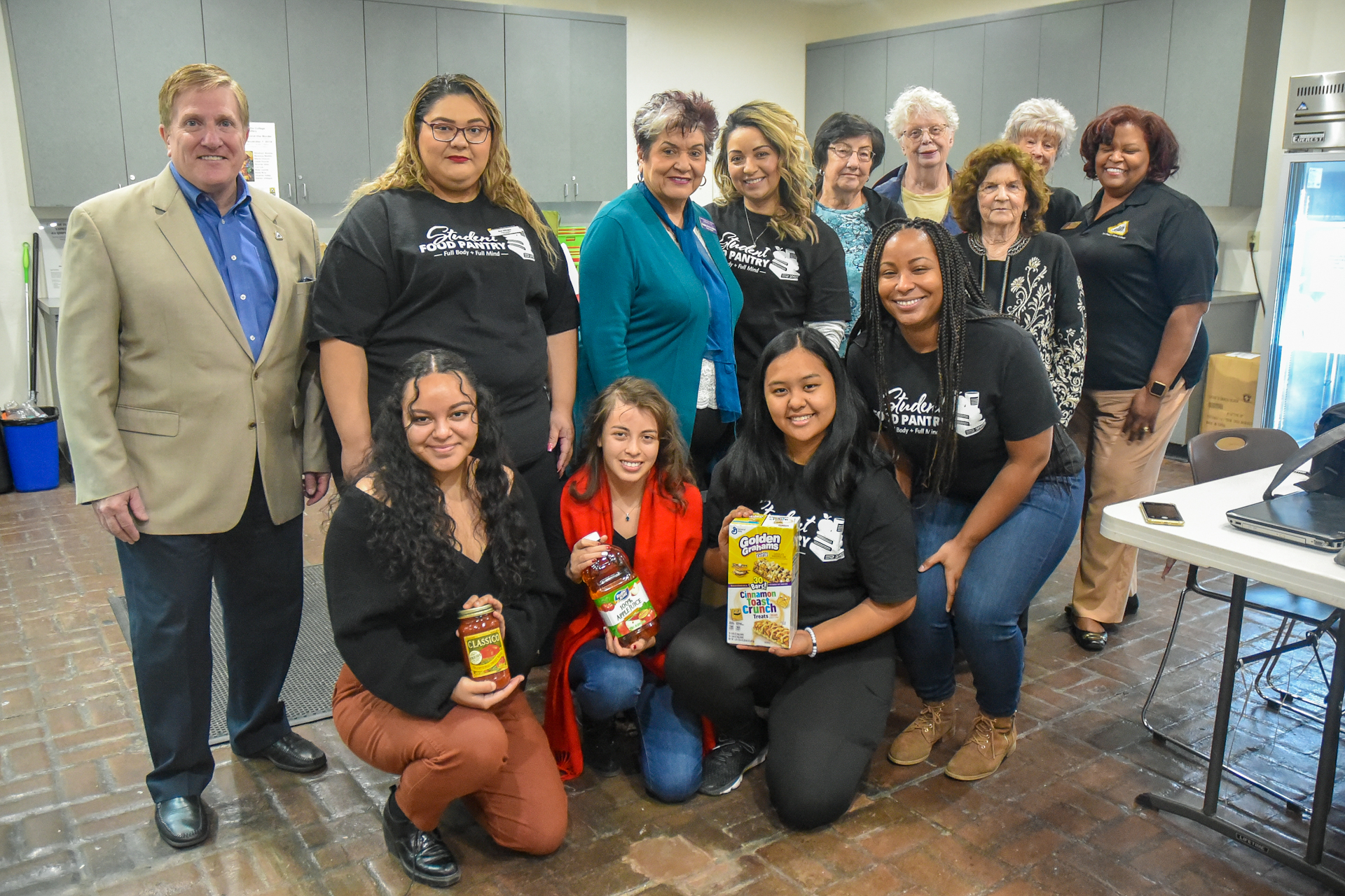 College officials, students and members of the Native Daughters of the Golden West pose with donations for the Student Food Pantry at San Joaquin Delta College.