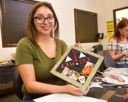 Graciela Villa enrolled at San Joaquin Delta College following the birth of her son, Adan. She was one of more than a dozen students through the CalWORKs program who decorated their commencement caps as a group this week.