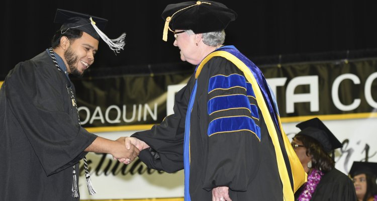 San Joaquin Delta College President Kathy Hart greets a new graduate after the College's 84th annual Commencement ceremony at Stockton Arena on May 23.