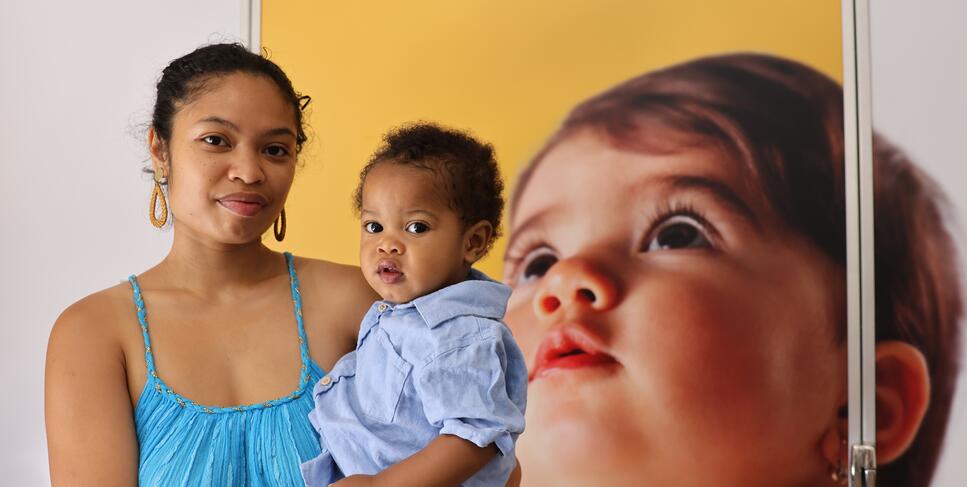 A student and her child pose for a photo outside one of the new lactation pods.