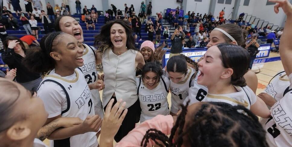 Delta women's basketball players celebrate their first state championship.