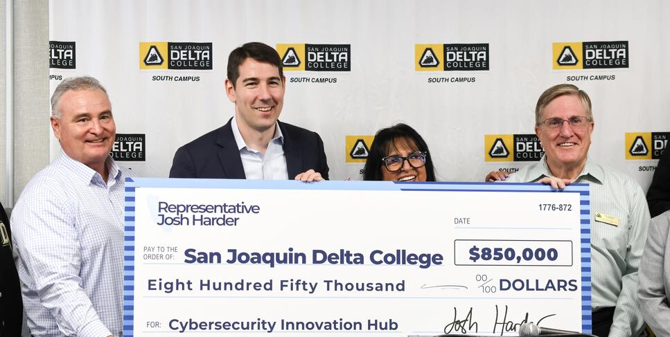Photo of Congressman Josh Harder presenting a check to Delta College