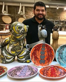 Guillermo Guardia stands with his portratis