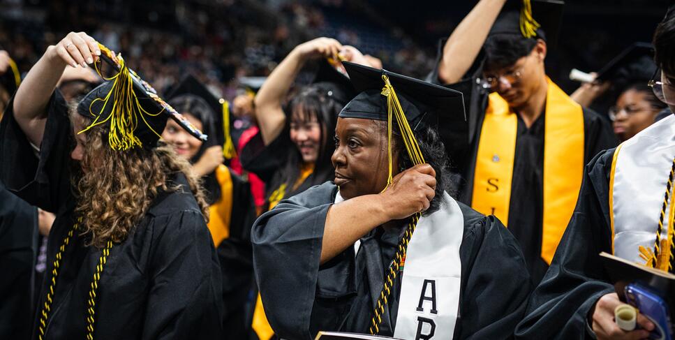 Photo of a student turning her tassel at Commencement.