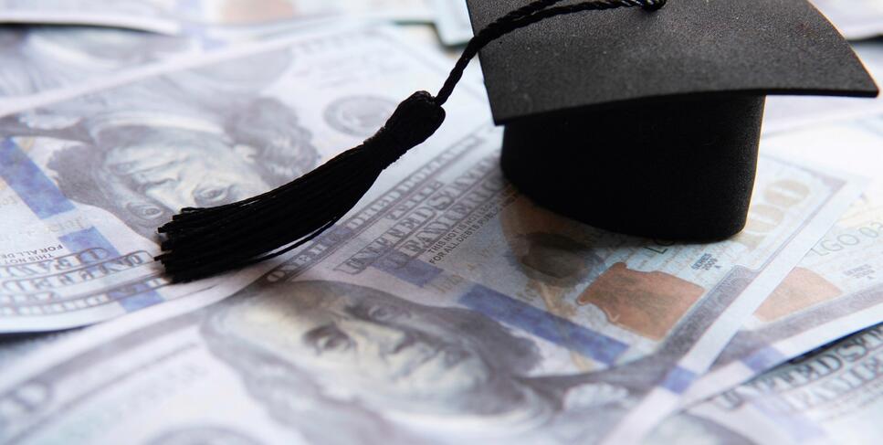 Photo of a graduation cap and money