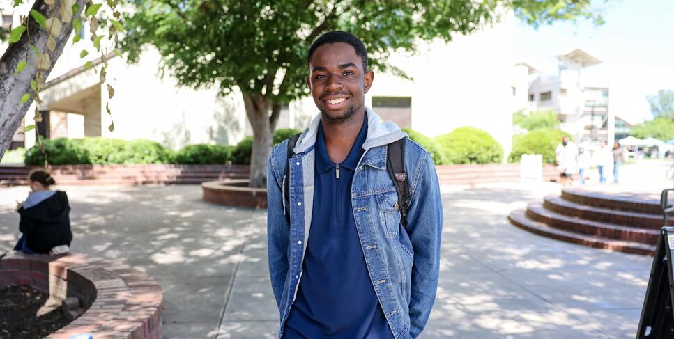 Photo of a student posing for a photo in the Delta College quad