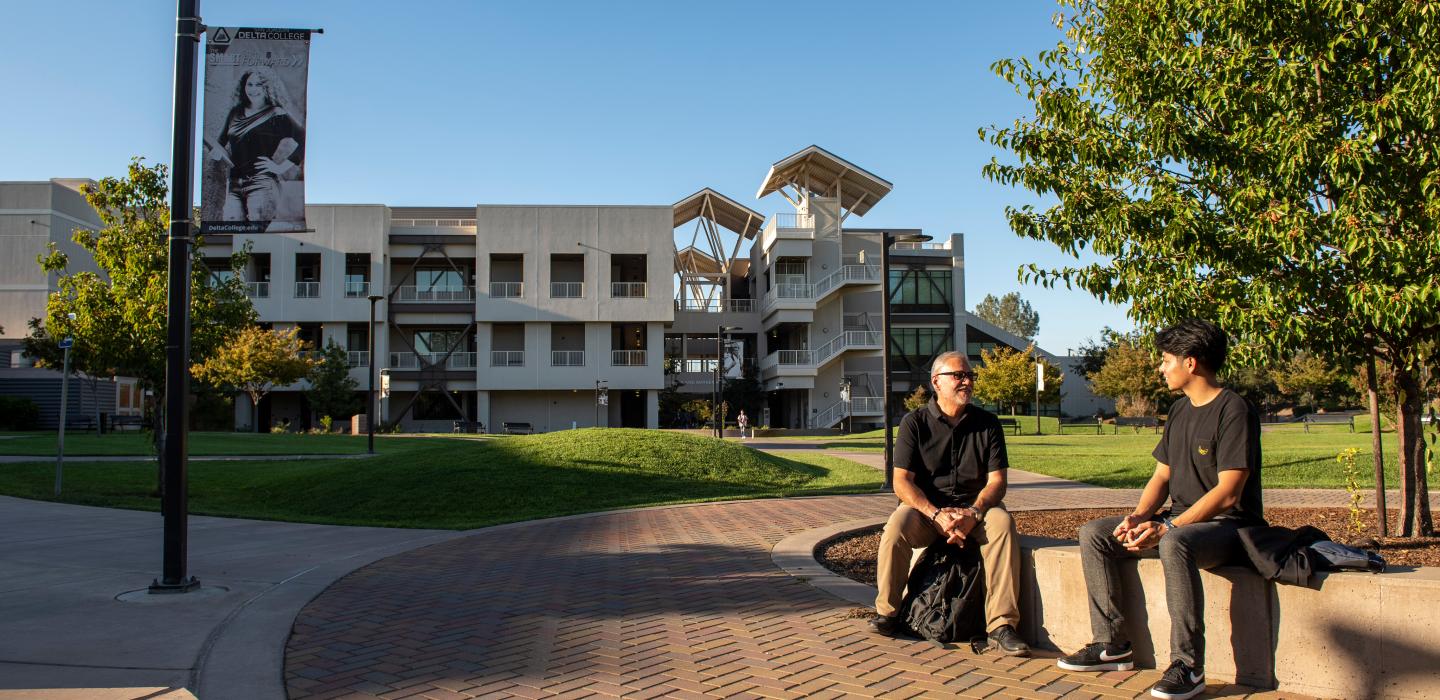 tow people talking in the college garden