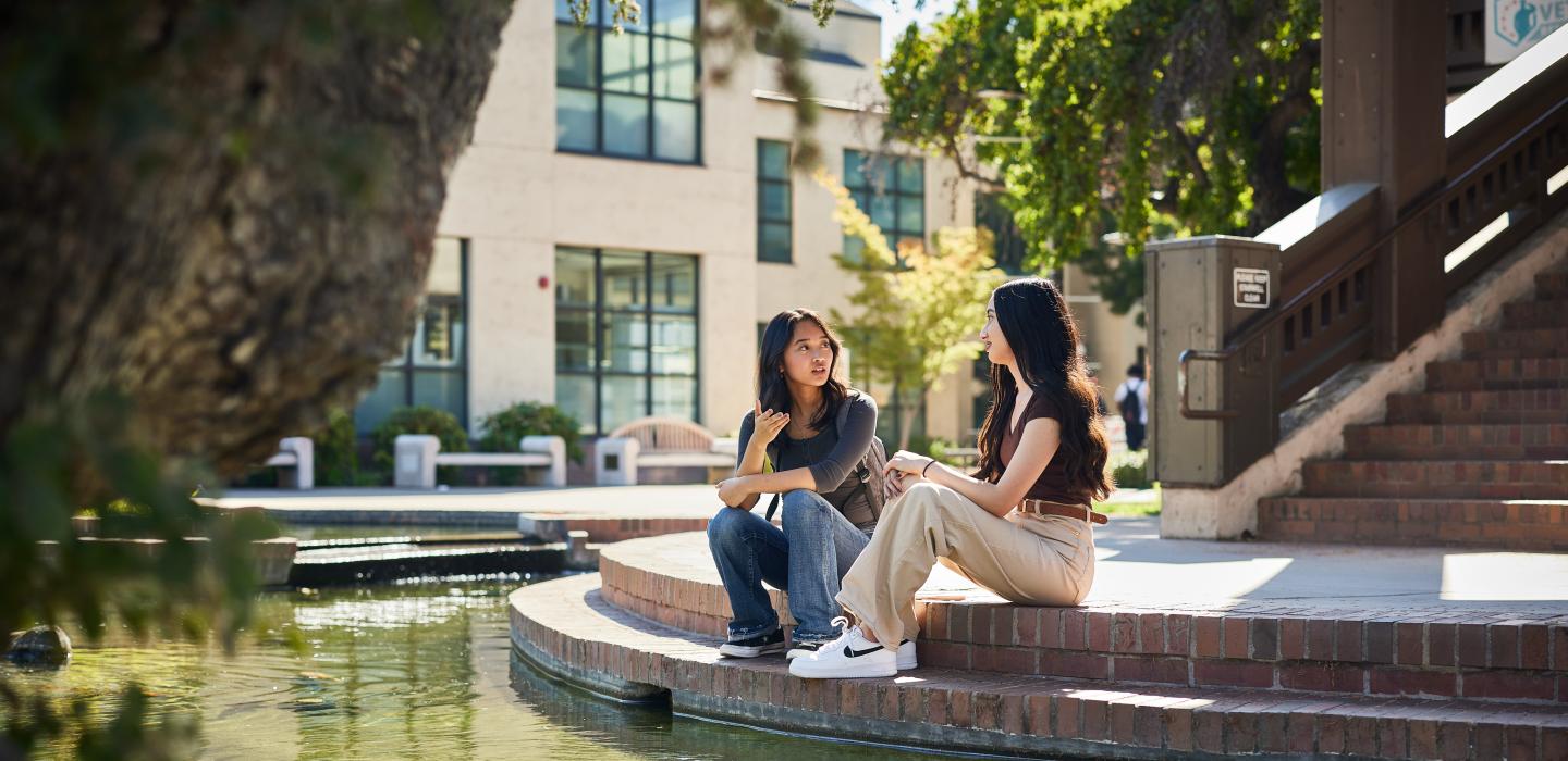 two girls talking on the stairs
