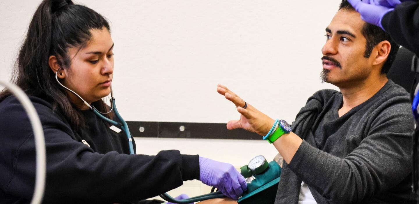 An instructor talks with EMT students