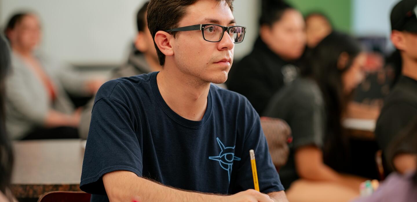 A student focuses on the instructor during a lesson on nutrition