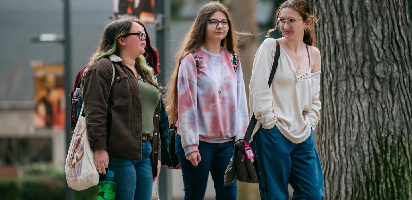 A group of Delta students strolls across campus