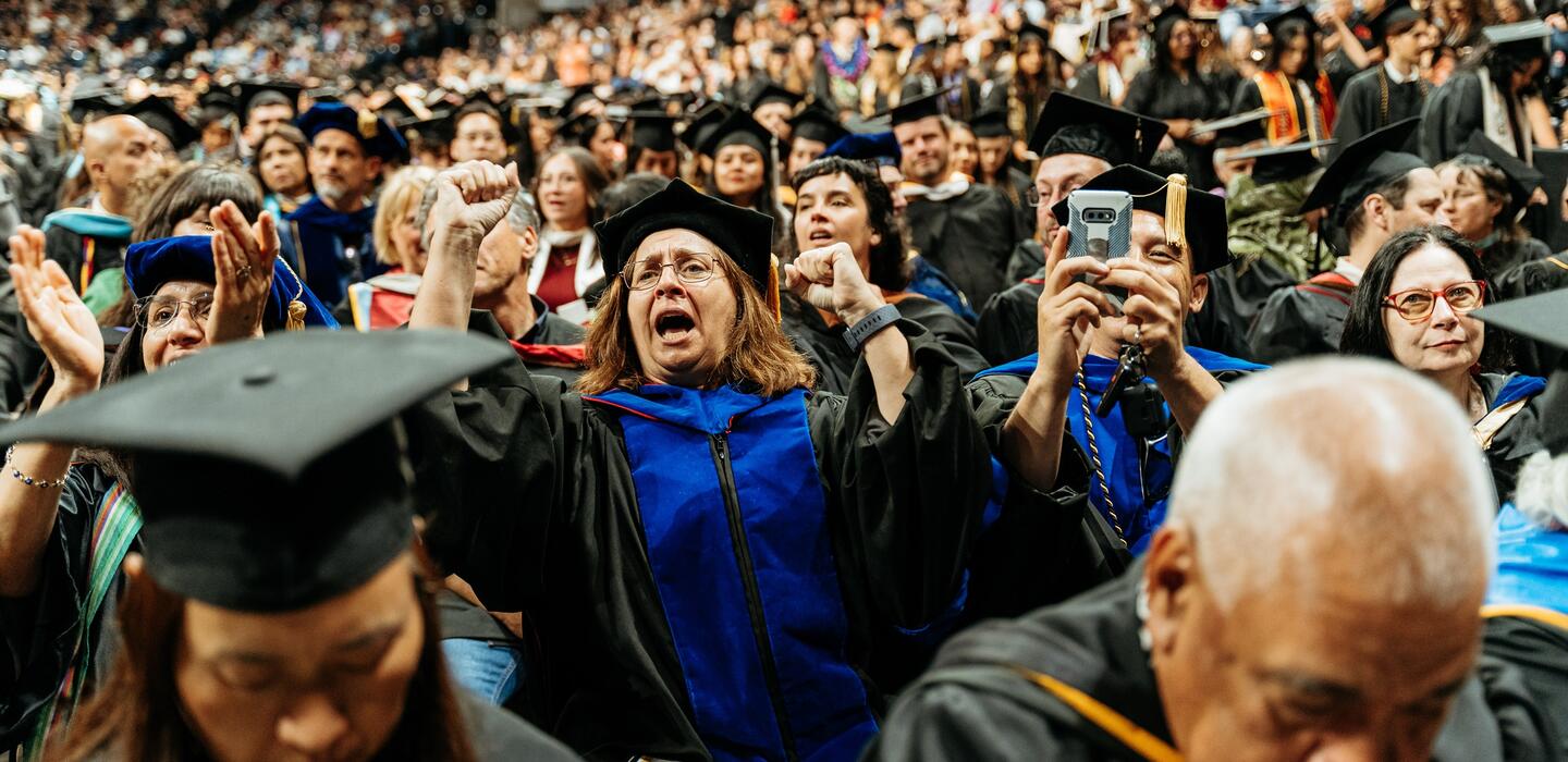 Photo of faculty cheering on students at Commencement