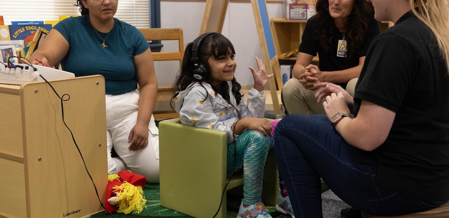 A Speech Language Pathology Assistant student administers a test to a child