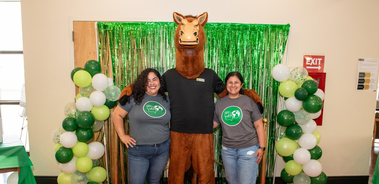 Fierce the Mustang poses with a dean and academic advisor from the Communication and Languages TrAC