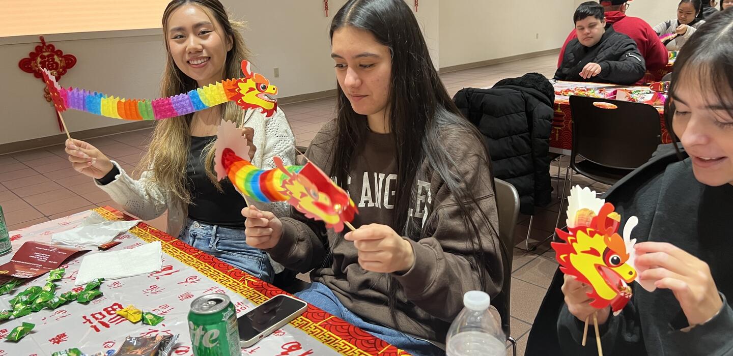 Students making craft dragons for Lunar New Year Celebration