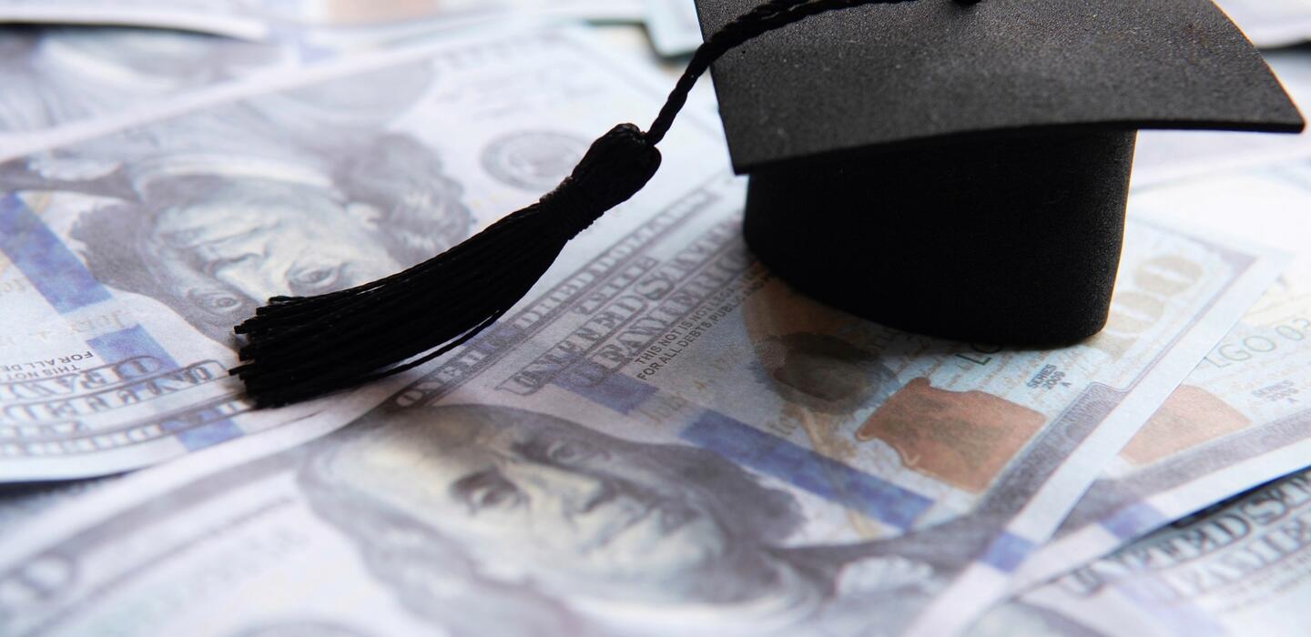 Photo of a graduation cap and money