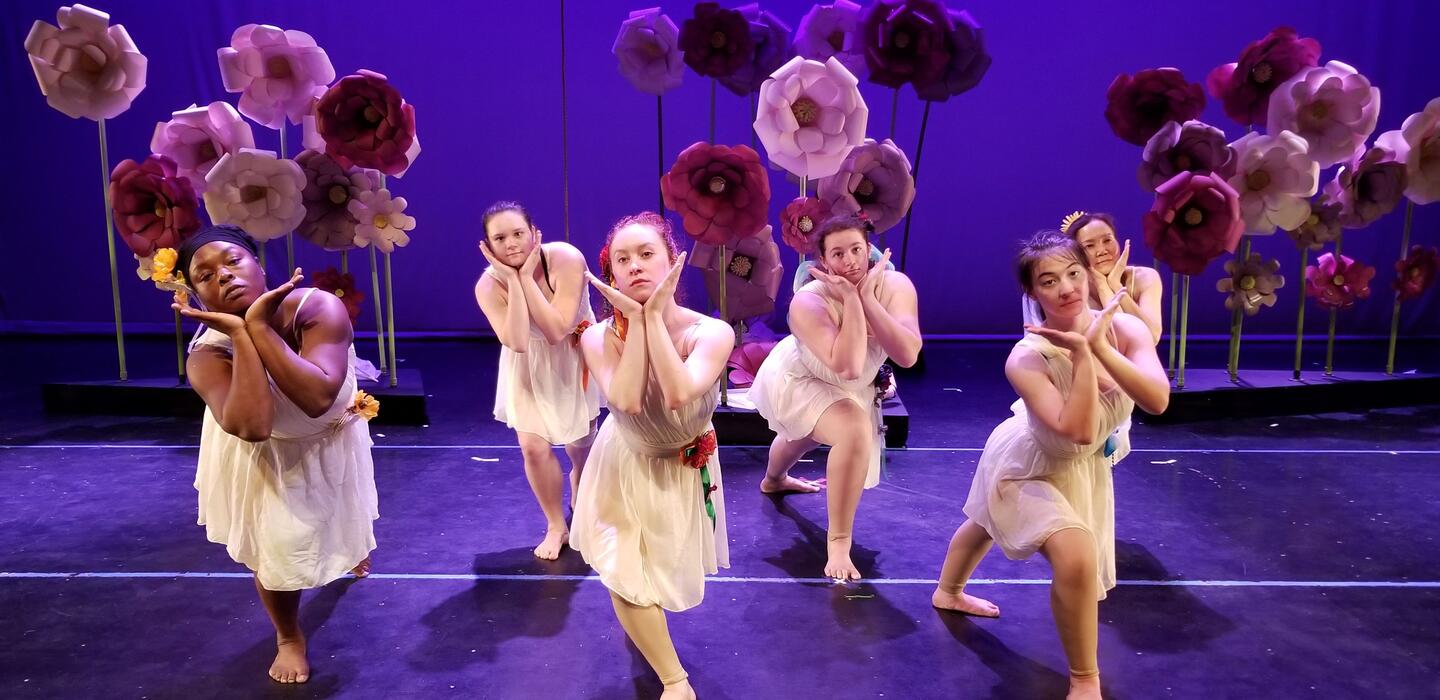 A group of dancers performing on stage 