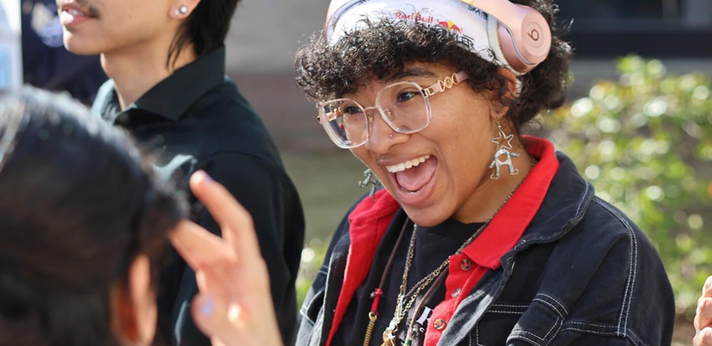 A fashion student smiles at Club Rush