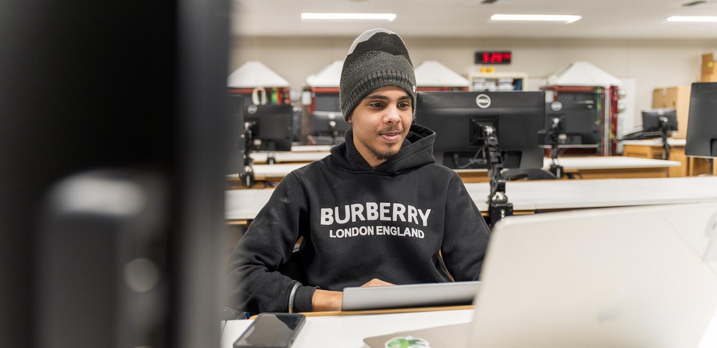 A student works in his business information management class