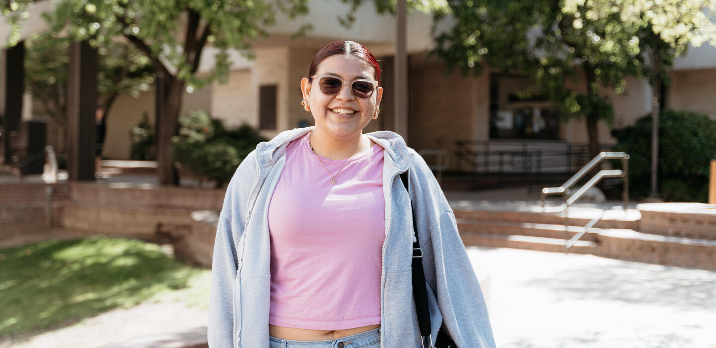 Student in Quad area standing and smiling