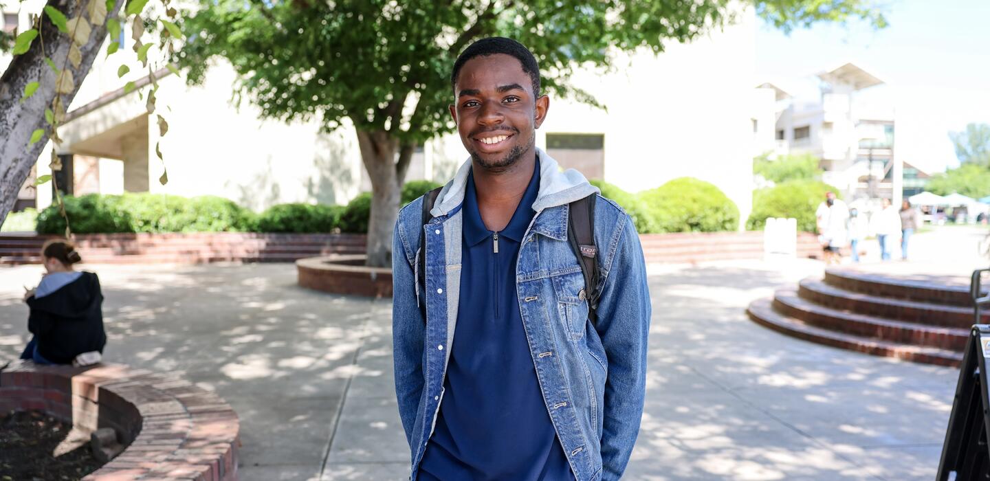Photo of a student posing for a photo in the Delta College quad