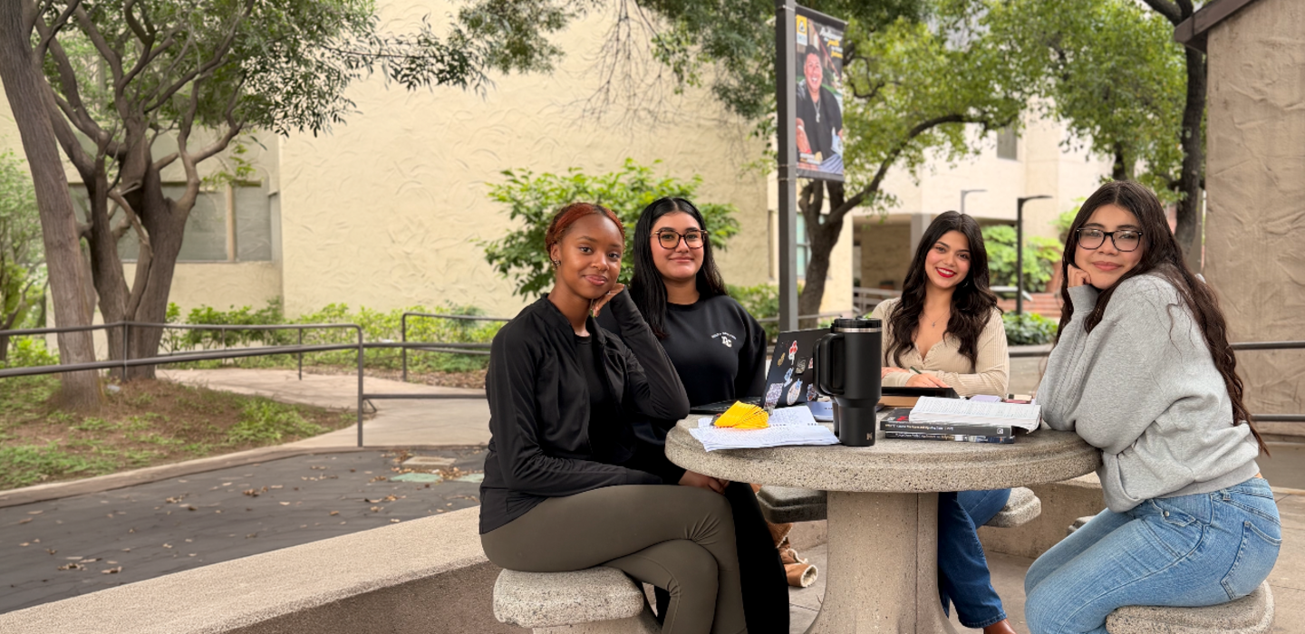 Student sitting at Table near Bookstore