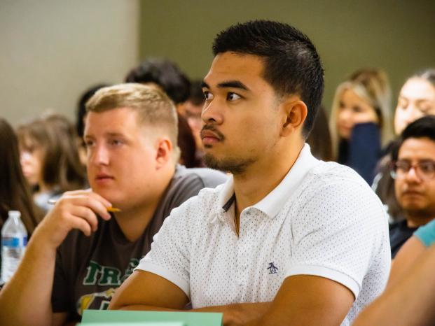Students attentively listen to a speaker during an engaging lecture in a classroom setting.