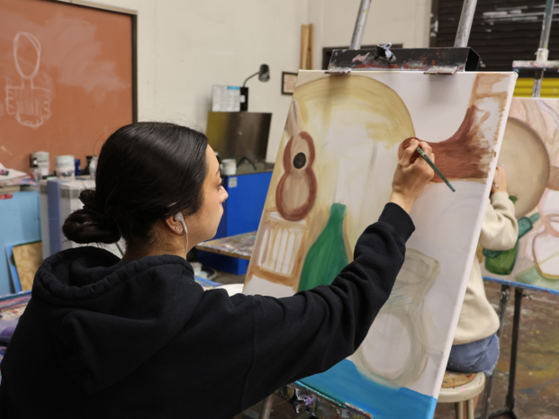 Girl painting a screen