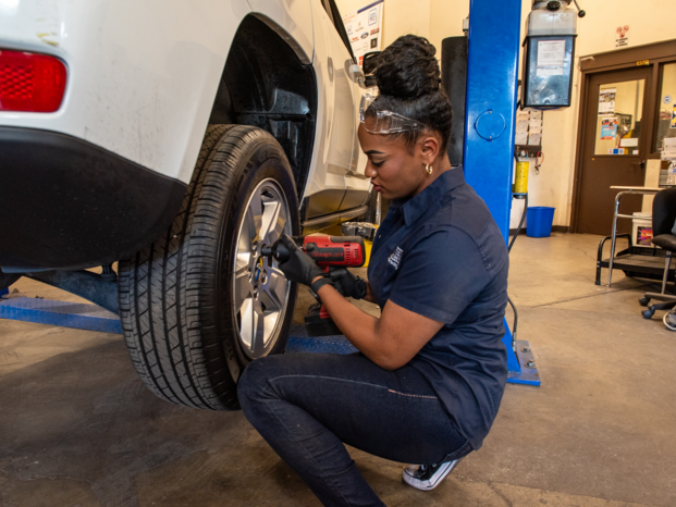 Student changing a tire