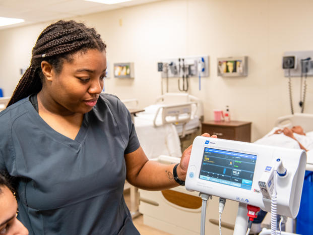person looking to the heart monitor